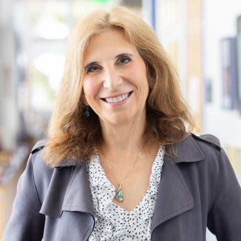 Denise Montell wearing a blouse and a jacket