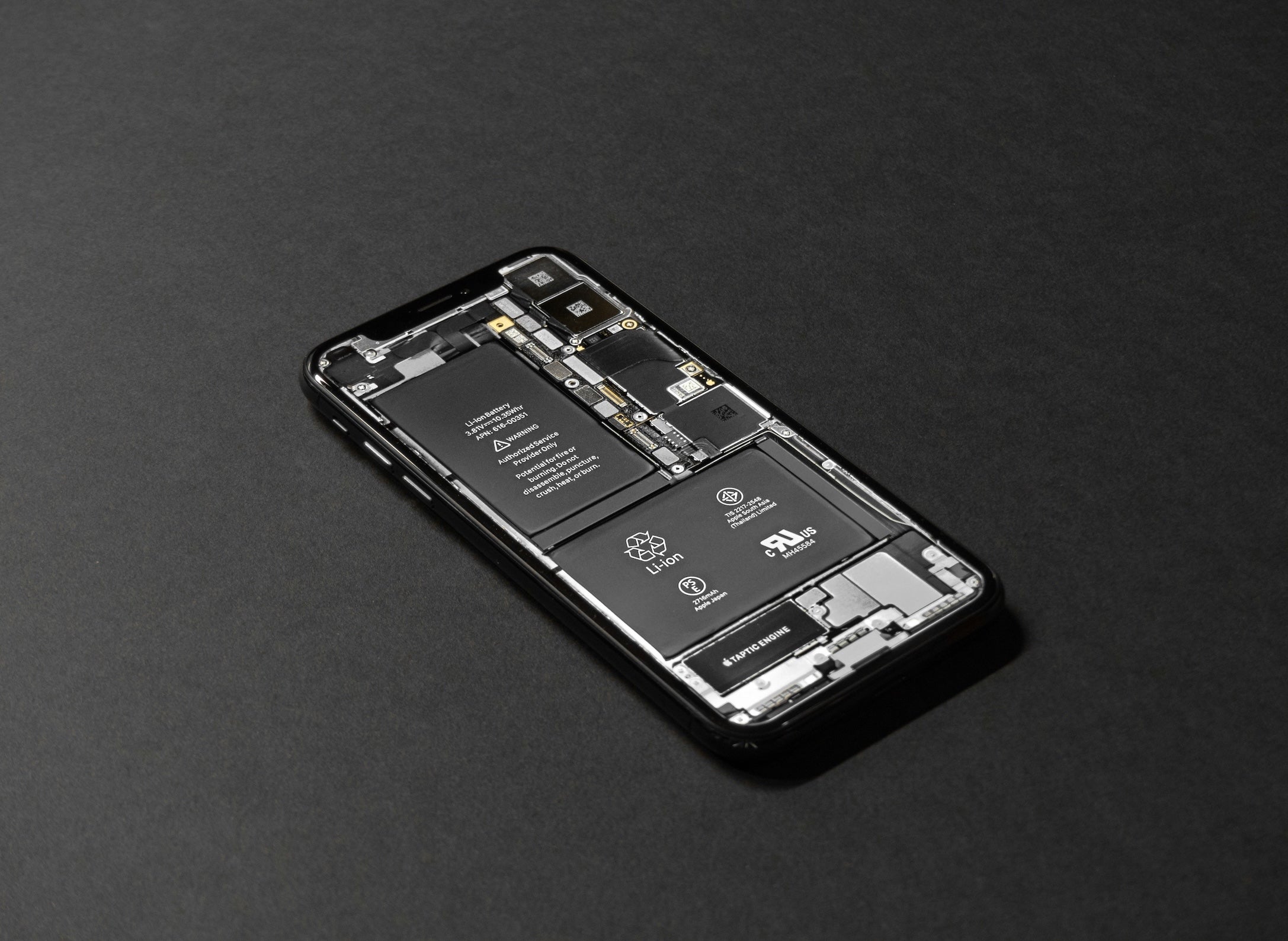 The open back of a smartphone shows lithium-ion batteries inside